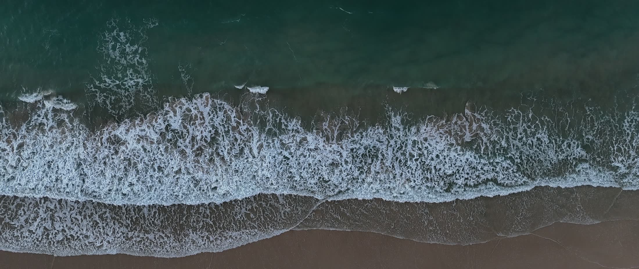 The shoreline at Bilinga from above, water meeting sand
