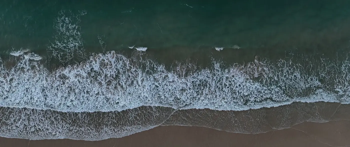 The shoreline at Bilinga from above, water meeting sand